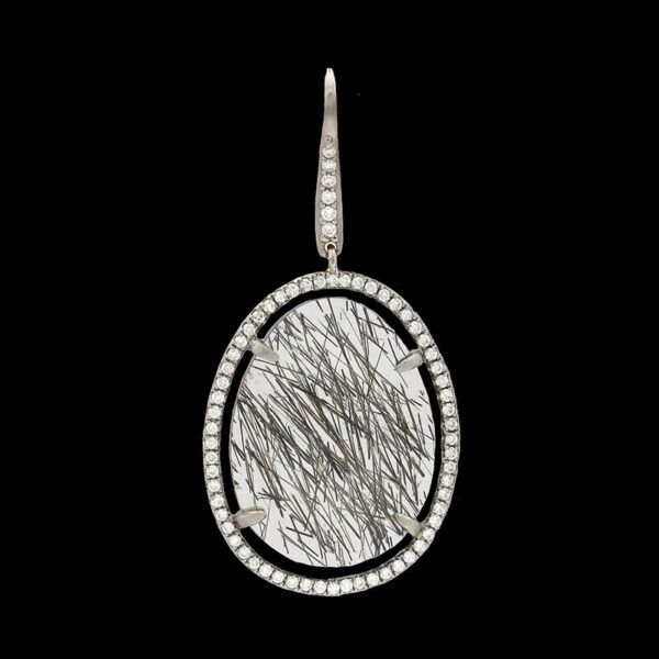 an oval shaped pendant with white and black lines