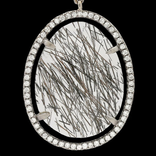 an oval shaped pendant with white diamonds