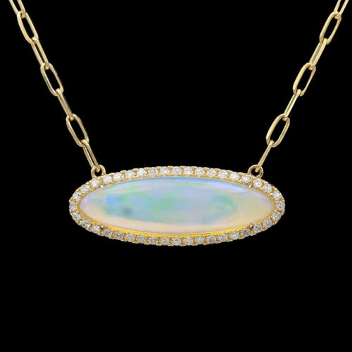 a necklace with an oval shaped white opal surrounded by diamonds