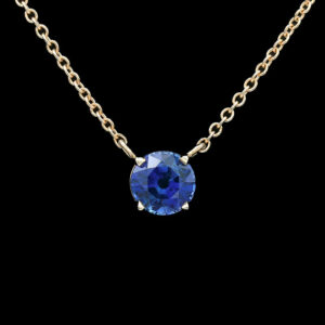 a necklace with a blue stone on it
