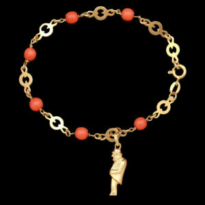 a gold bracelet with an orange beaded charm