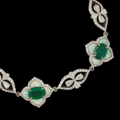 an art deco necklace with green and white stones