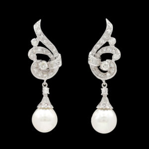 a pair of white pearls and diamond earrings