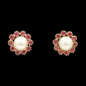 a pair of earrings with pearls and pink stones