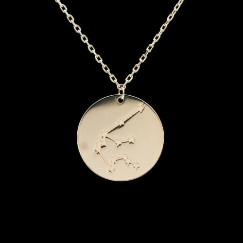 a gold necklace with a zodiac sign on it