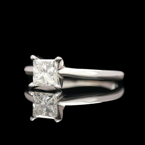 a close up of a diamond ring on a black background