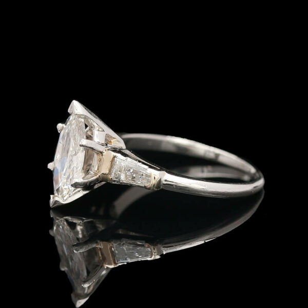 an old cut diamond ring on a reflective surface