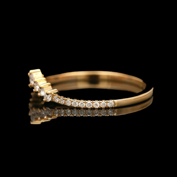 two gold rings with diamonds on black background