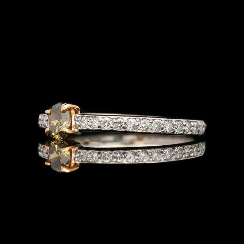 a yellow and white diamond ring on a black background