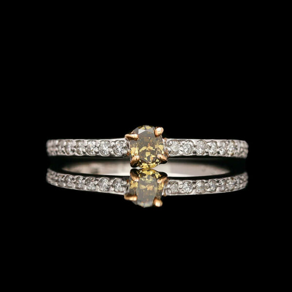 a fancy yellow diamond ring on a black background