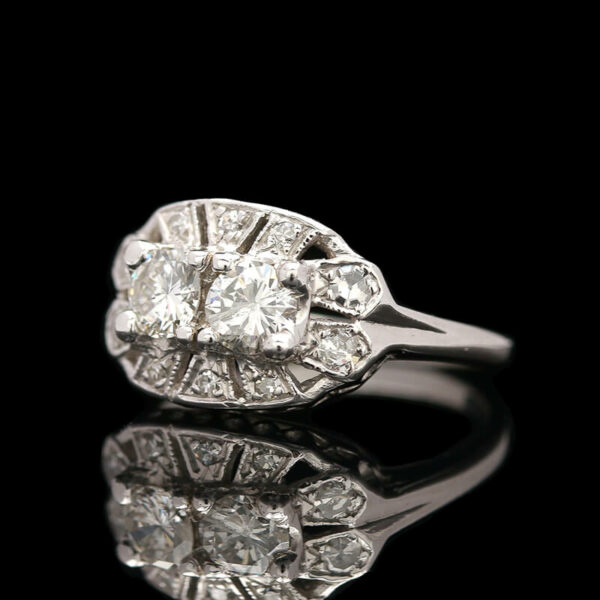 an antique diamond ring on a reflective surface
