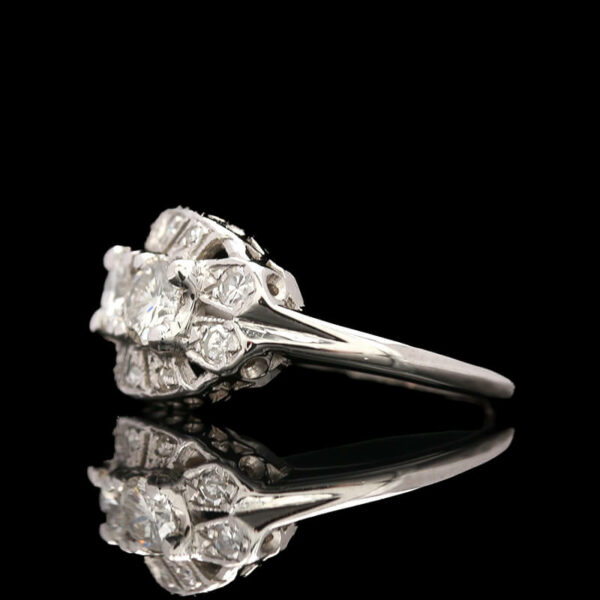 an antique diamond ring on a reflective surface