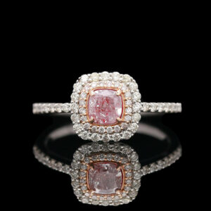 a fancy ring with a pink diamond in the center