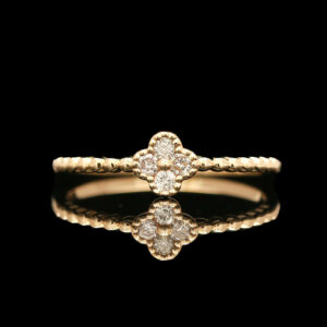 a gold ring with three diamonds on it
