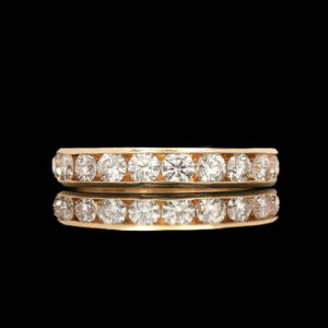 two yellow gold rings with diamonds on them