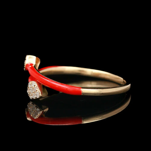 a red and gold ring with diamonds on it