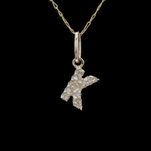 a gold necklace with a letter k on it