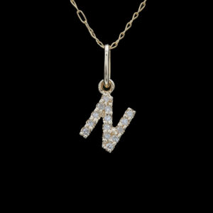 a diamond initial necklace with the letter n on it