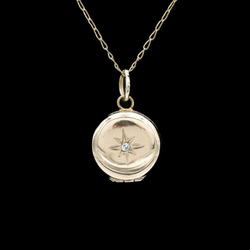 a small compass pendant on a chain
