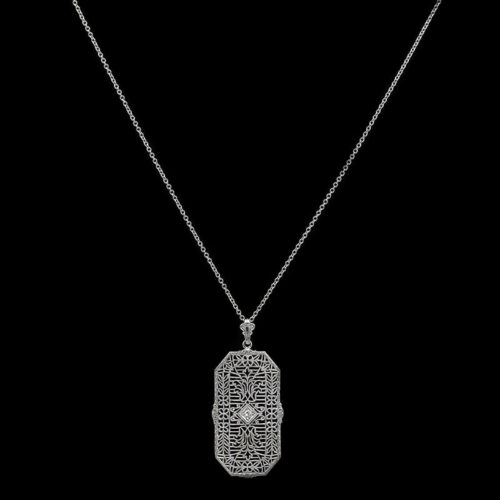 a silver necklace with a hamsa on it