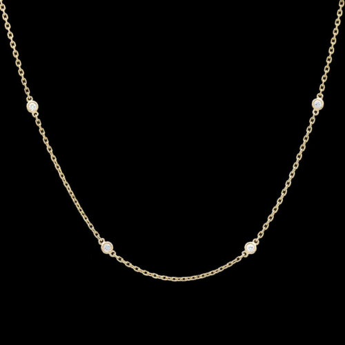 a gold chain with three diamonds on it