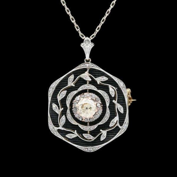 a black and white diamond pendant on a chain