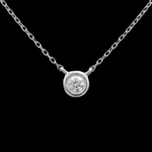 a silver necklace with a white diamond on it