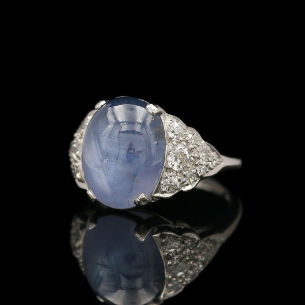a ring with a large blue stone surrounded by diamonds