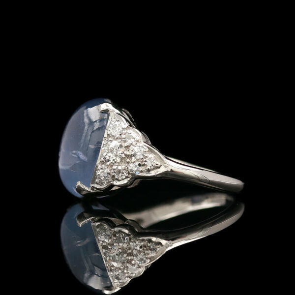 a diamond ring with a blue stone in the middle