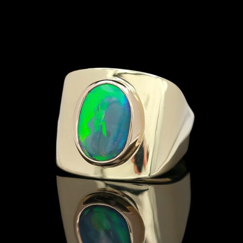 a ring with a green and blue stone in it
