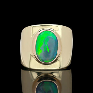a ring with an oval shaped green and blue stone