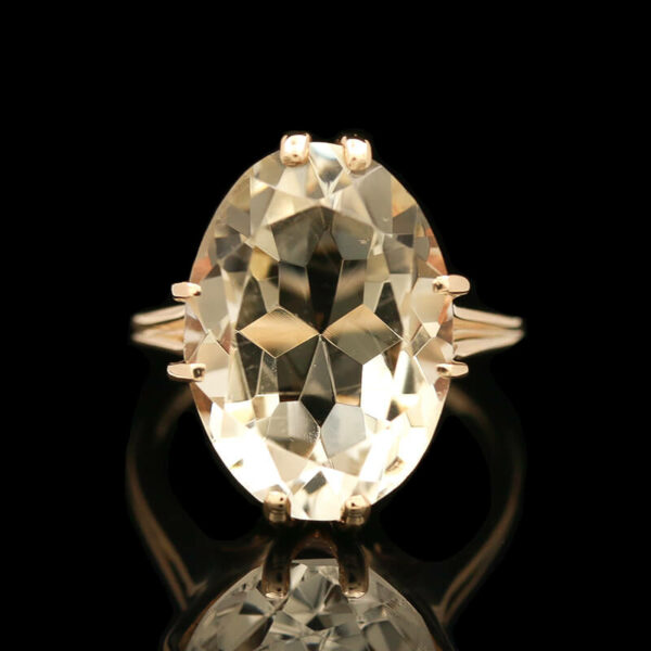 an oval shaped diamond ring with two small diamonds