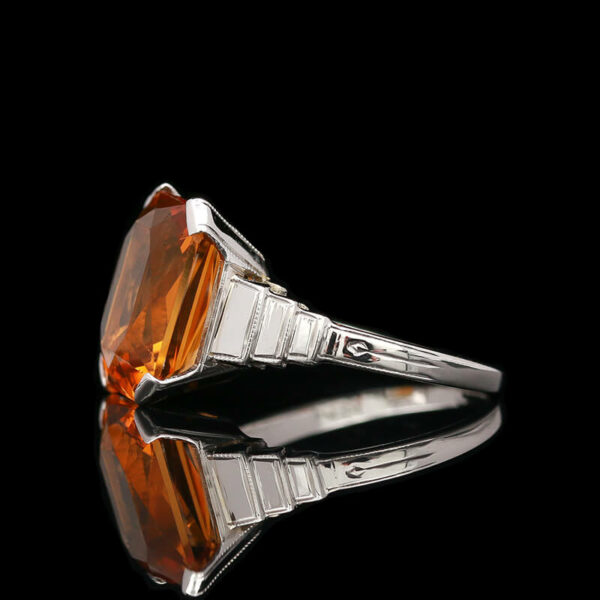 a ring with an orange stone in it
