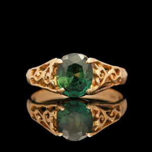 an oval green tourmaline ring with intricate filigrees