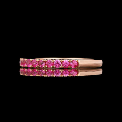 a close up of a pink ring on a black background