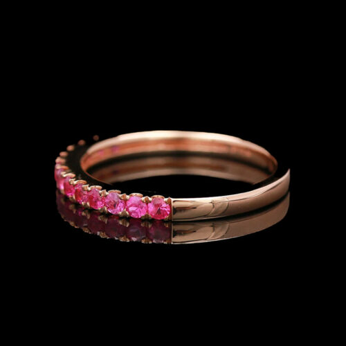 a close up of a ring with pink stones