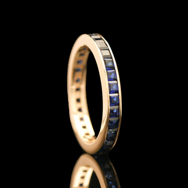 a gold ring with blue sapphire stones