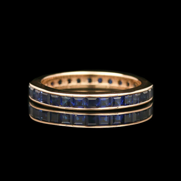 a gold ring with blue sapphire stones