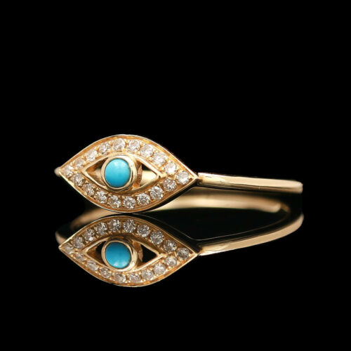 a gold ring with an evil eye and diamonds