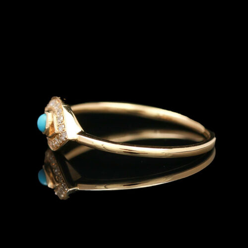 a yellow gold ring with a turquoise stone