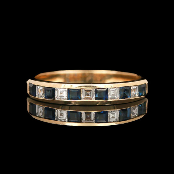 two gold rings with blue and white diamonds