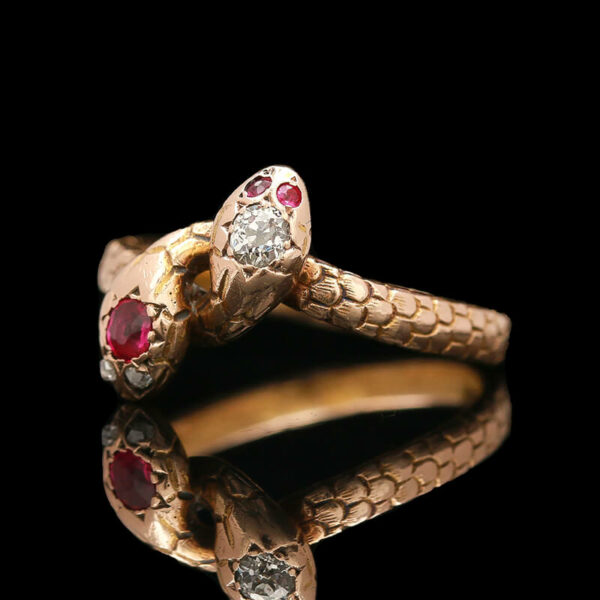 a snake ring with three stones on it
