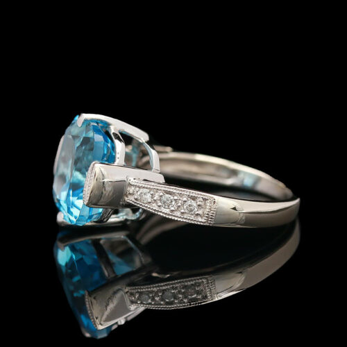 a ring with a blue topaz and diamond accents