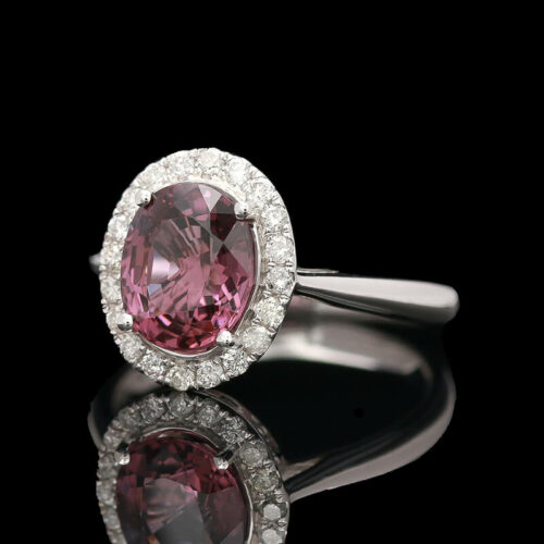 an oval shaped pink diamond surrounded by white diamonds