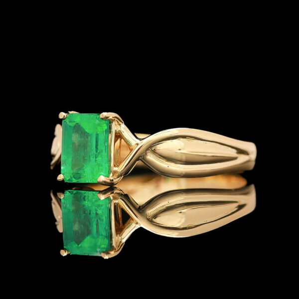 a ring with two emeralds on it