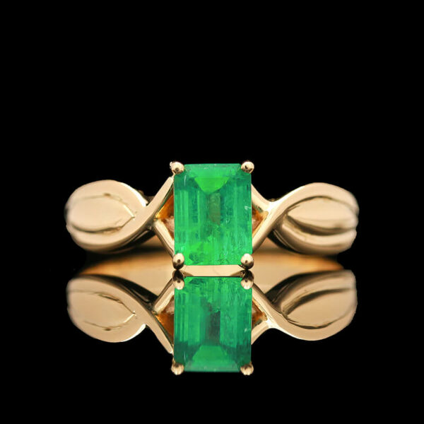 an emerald ring with two leaves on it