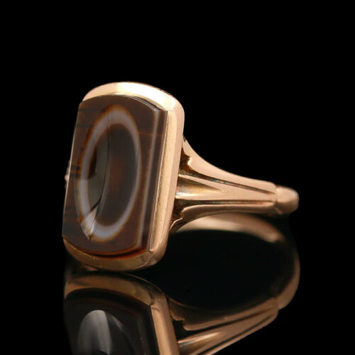a gold ring with a brown and white stone