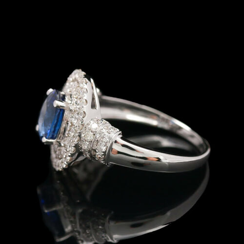 a blue and white diamond ring on a black background