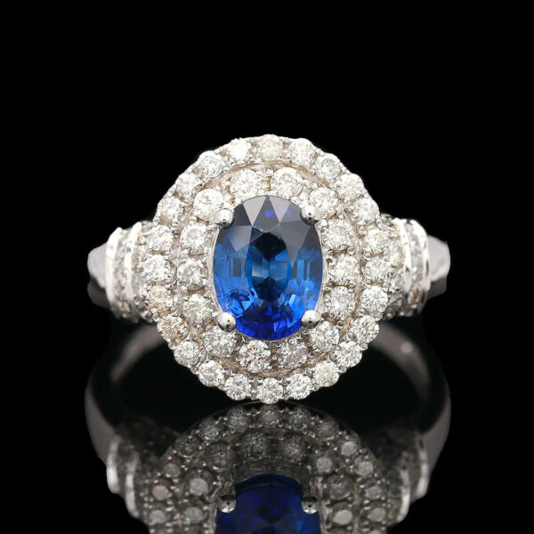 a blue and white diamond ring on a black surface