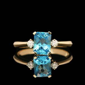 a blue topazte and diamond ring on a black background